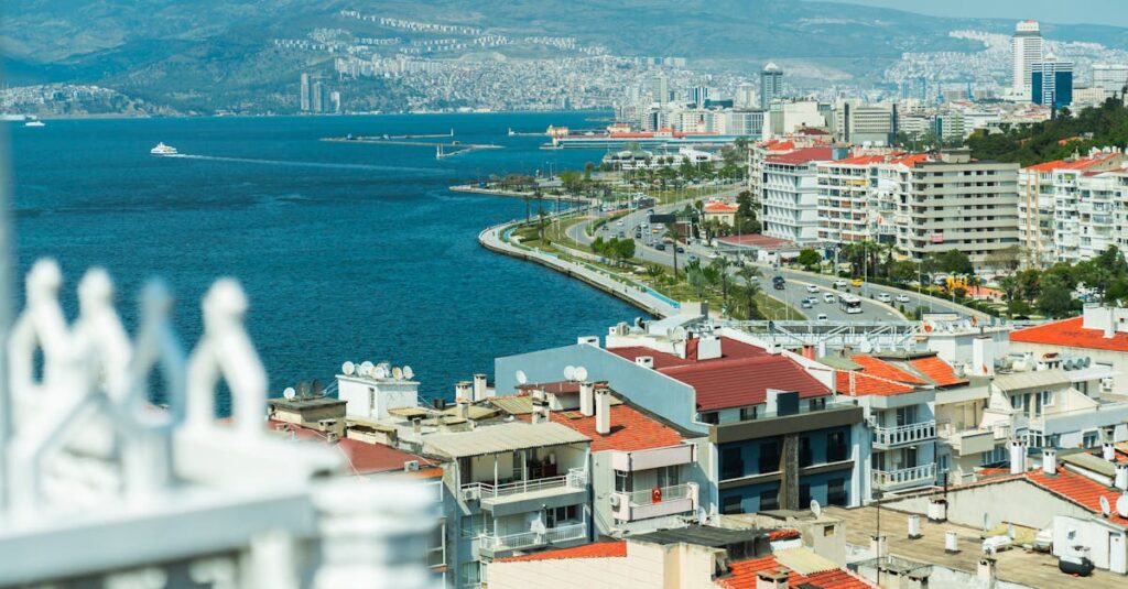 Aerial view of Izmir's coastline featuring vibrant buildings and the Aegean Sea.
