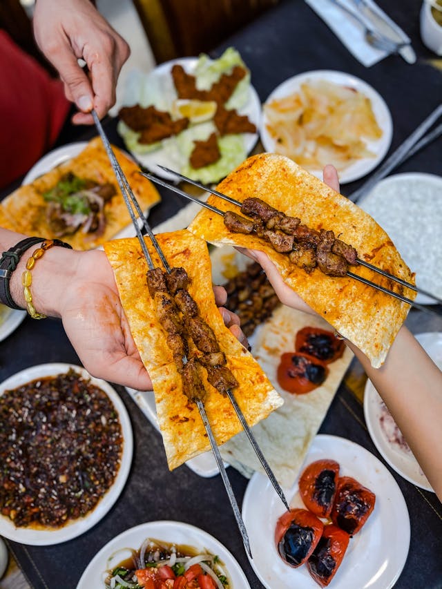 Turkish kebab, delicious grilled meat skewers served on flatbread with various side dishes